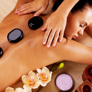 Adult woman having hot stone massage